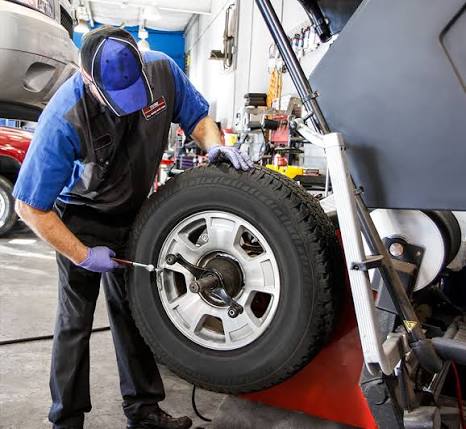 Technician balancing a tire and wheel