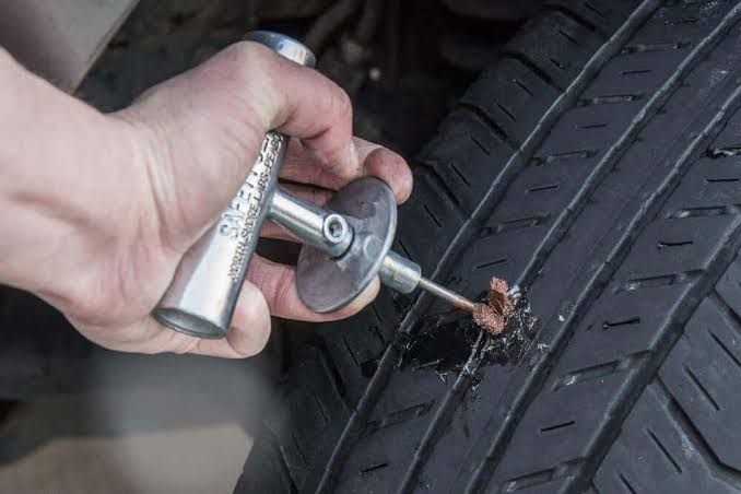 Technician performing a tire patch and plug repair