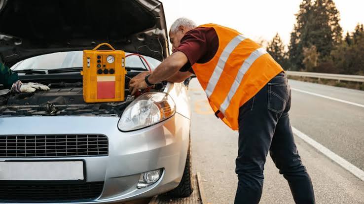 Technician providing roadside tire assistance