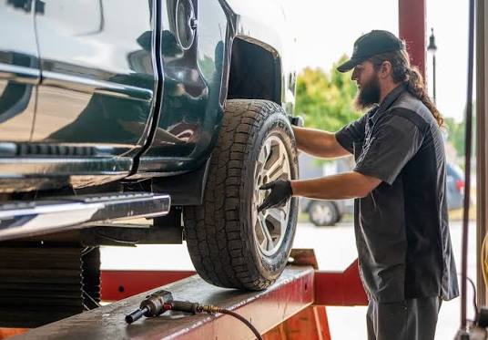 Technician performing a tire rotation service